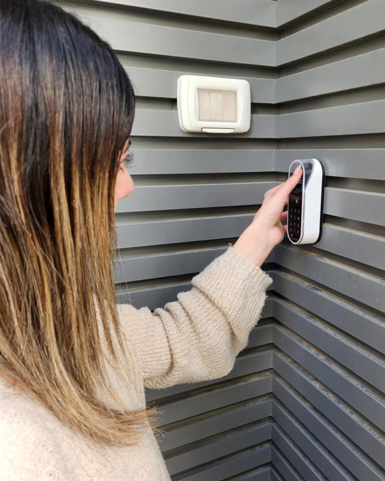 Fingerprint and touch code of an entr smart lock. Unit is on a decorated wall. A woman opens a door with a fingerprint.