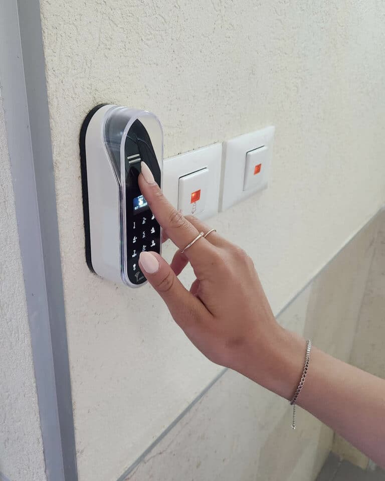 Fingerprint and touch code of an entr smart lock. Unit on the wall. A woman opens a door with a fingerprint.