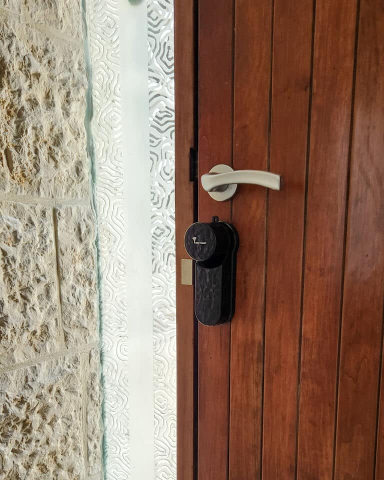 Smart lock _Entr_ black finish. A brown wooden door, installed by smart lock israel.
