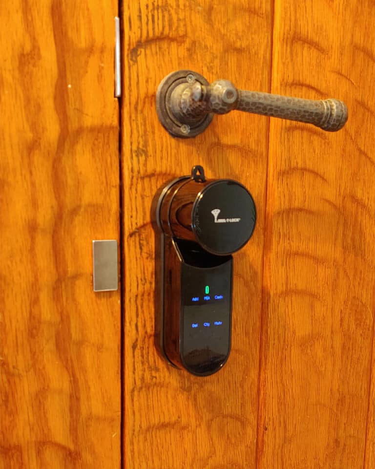 Smart lock _Entr_ black finish. a wooden door installed by smart lock israel.